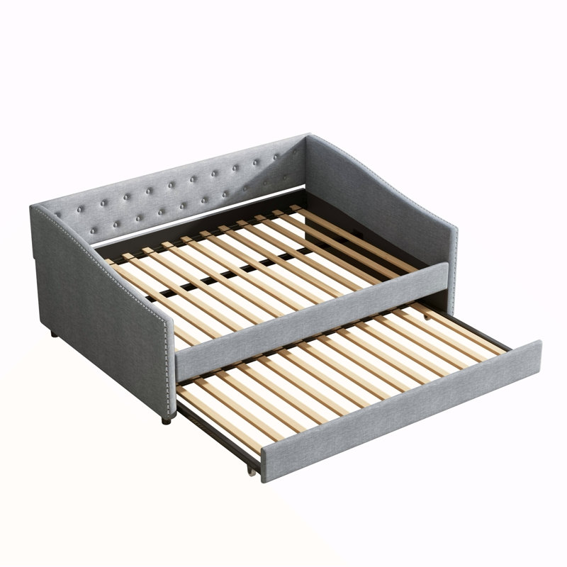 Lit de jour double avec couchette simple, dossier capitonné et accoudoirs ondulés en gris clair, parfait pour le confort et le style