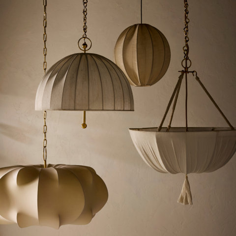 Four fabric pendant lights hang against a neutral wall.