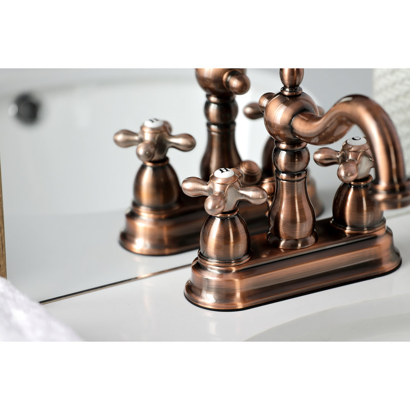 Robinet de salle de bain central à deux poignées et 3 trous à fixation sur le comptoir de 4 po avec bonde escamotable en plastique Kingston Brass Heritage
