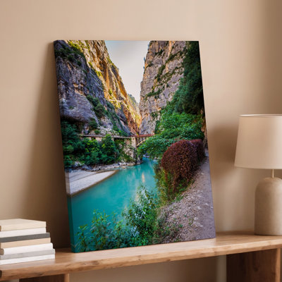 Canvas A Breathtaking Canyon Scene Showcasing Towering Rugged Cliffs Adorned With Wall Art Patches Of Vibrant Greenery Illuminated By Canvas Wall Art