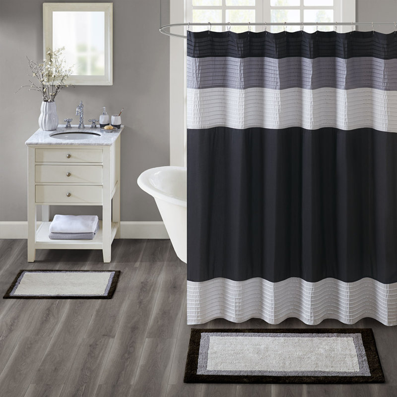 Tapis de bain antidérapant en coton au design élégant noir, idéal pour une salle de bain à séchage rapide