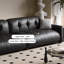 Causeuse-coussin modulable noire en cuir véritable