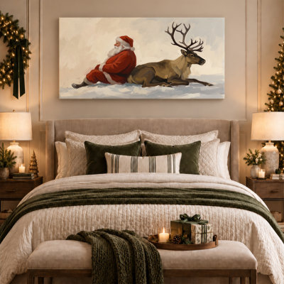 Art mural sur toile, "Père Noël assis à côté d'un renne dans la neige"