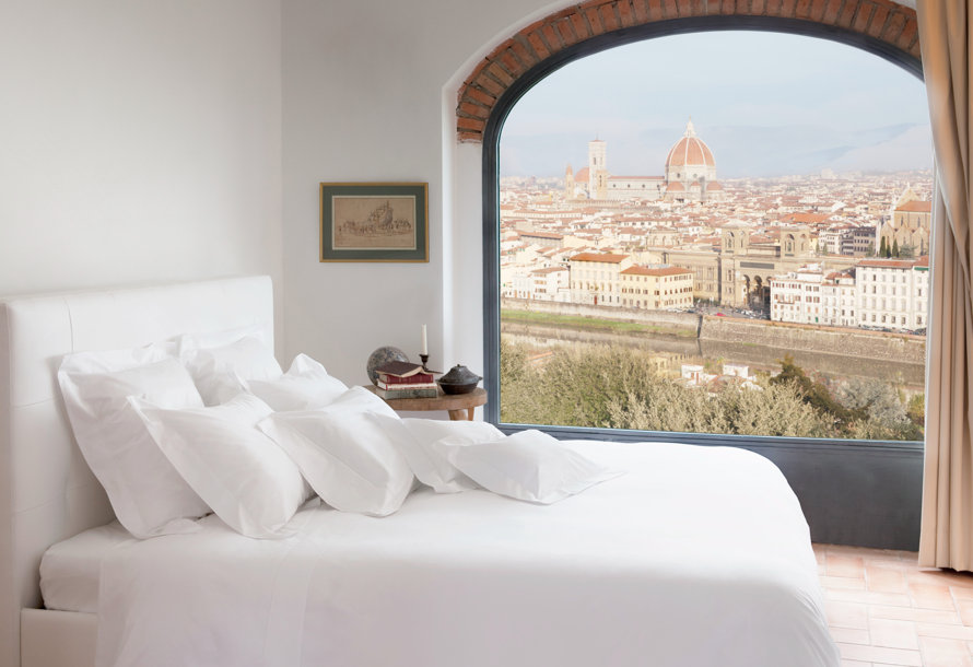 Bedroom with white linens overlooking the Duomo of Florence.