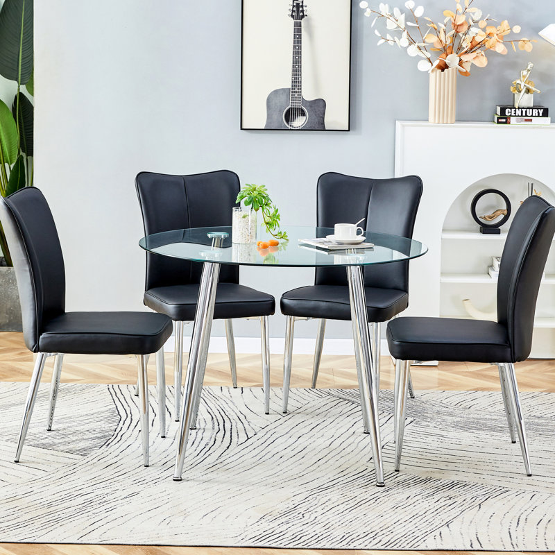 Verre transparent et salle à manger en métal argenté pour 4 personnes: table avec pieds en polyuréthane et chaises noires en polyuréthane