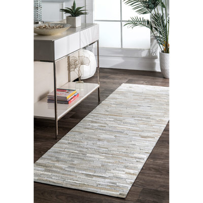 Quaeshia Area Rug in Beige