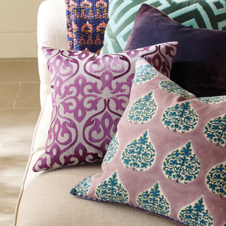 Assorted throw pillows on a sofa.