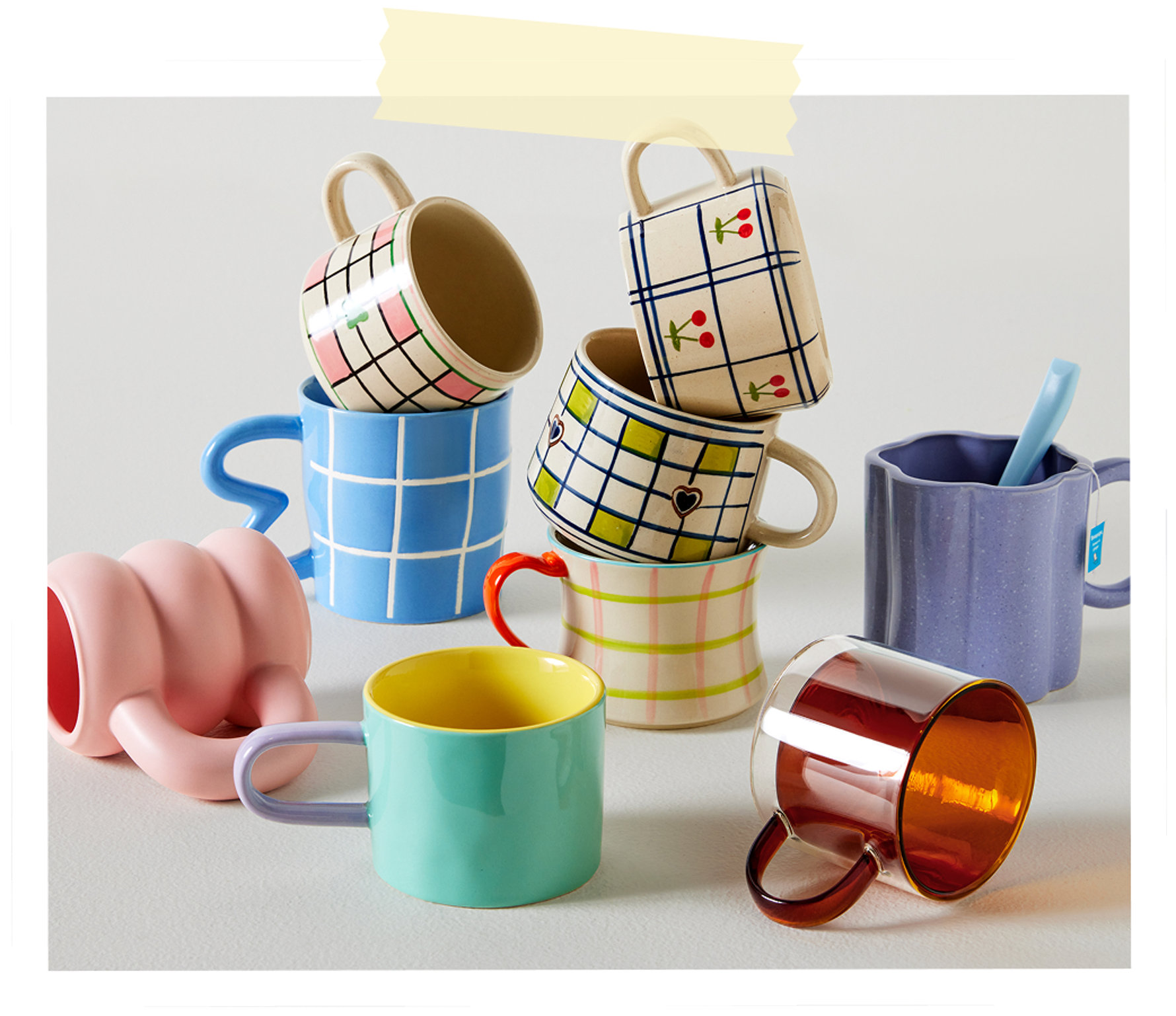 An assortment of colorful ceramic coffee mugs featuring checkered, striped, cherry, and bubble-textured designs.