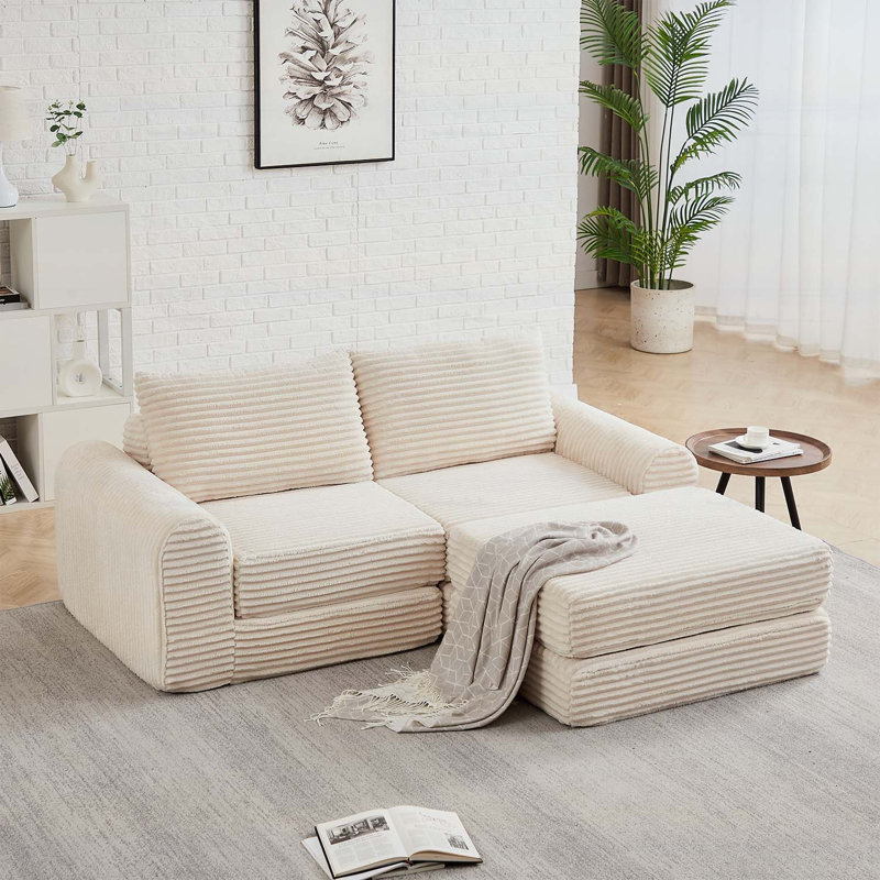Canapé minimaliste en velours côtelé avec lignes courbes et dossier légèrement incliné, canapé 2 en 1 et lit, comprend deux coussins décoratifs