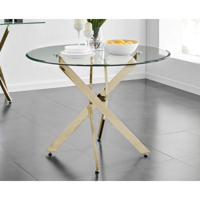 Le plateau de table circulaire en verre trempé moderne est jumelé à un cadre en fer doré mesurant 35,43 pouces de longueur.
