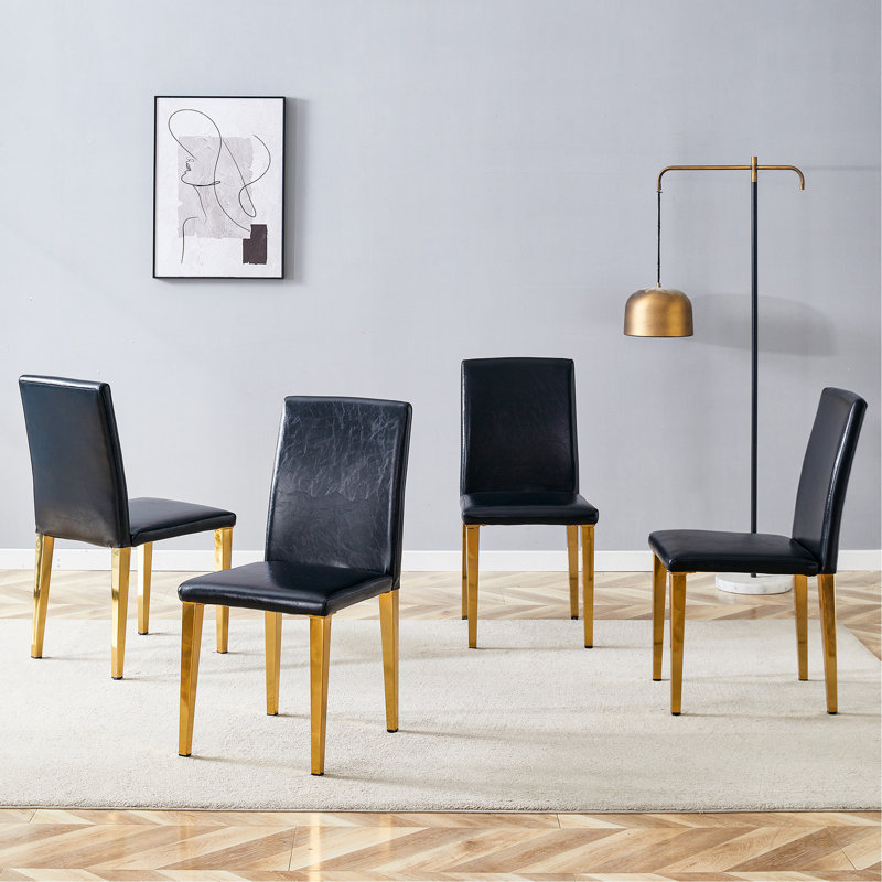 Quatre chaises de salle à manger en polyuréthane noir, pieds en métal doré. Simple et polyvalent, confortable et accompagné. Des chaises de salle à manger exquises et polyvalentes offrent une nouvelle expérience confortable. (Ensemble de 4)