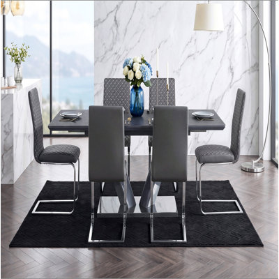 Table de salle à manger moderne et luxueuse à finition frittée avec plateau en forme de V et piédestal en chrome