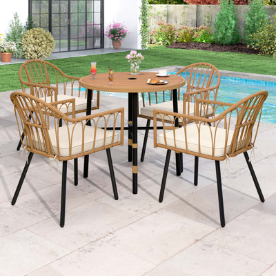 Feingold 4 - Person Wicker Patio Dining Set with Round Table , Cushions Included