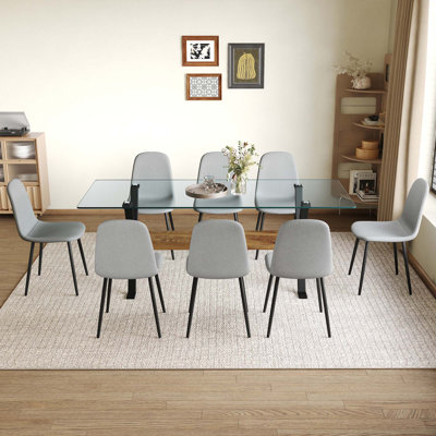 Ensemble de table et de chaises 79 po x 31,5 po avec pieds de table en métal noir en forme de X, traverse en panneau de fibres à densité moyenne à grain de bois texturé. Assorti de 10 chaises en tissu Lnen gris foncé. Pieds de pulvérisation en tube de fer.