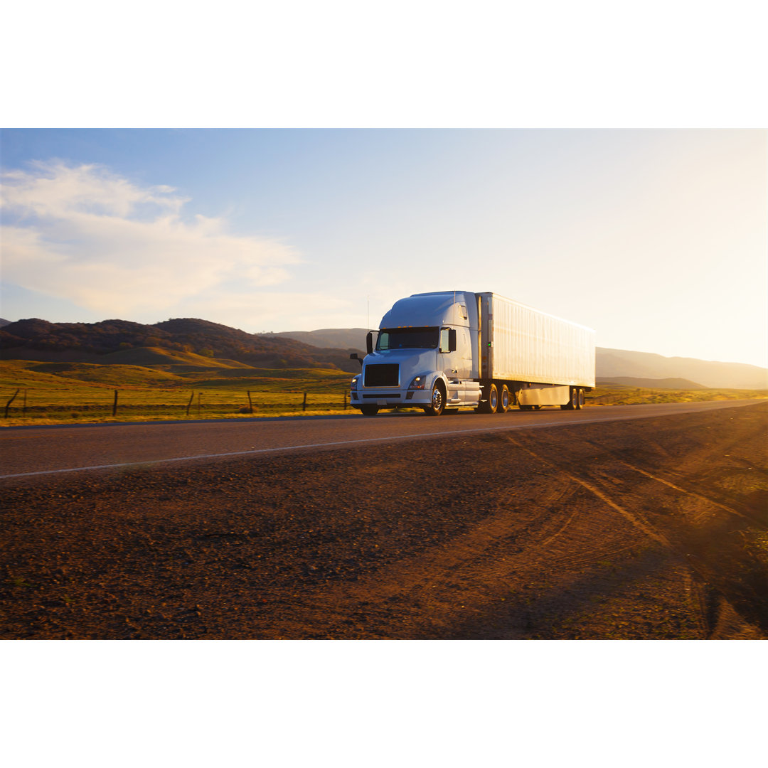 Truck On Highway At Sunset von Stellalevi - Kunstdrucke ohne Rahmen auf Leinwand