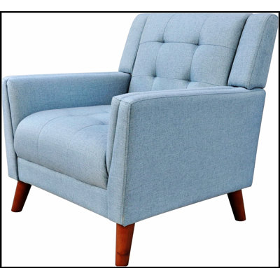 Fauteuil de style Mid-Century moderne avec pieds évasés et revêtement capitonné, parfait pour des sièges élégants et confortables dans tout espace de détente.