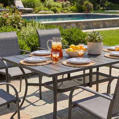 Cihangir Rectangular 6 - Person 60'' L Outdoor Patio Dining Set with 6 Stackable PVC-coated polyester Armrest Chairs