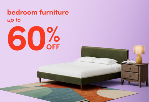Bedroom furniture up to 60 percent off, featuring a green upholstered bed, a wooden nightstand, and a colorful patterned area rug on a light purple background.