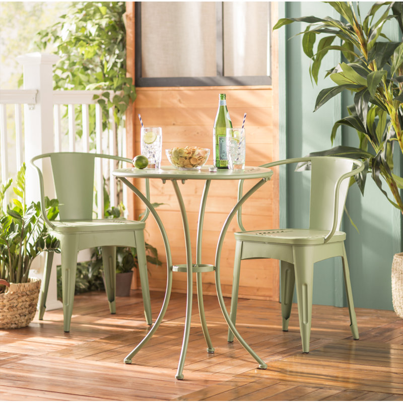 Ensemble bistro traditionnel pour 2 personnes avec table ronde, fauteuils en fer forgé, motif floral et design empilable Alan