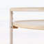 Chariot-bar rond avec tablettes en verre trempé et accents dorés, finition blanche vieillie, idéal pour les décors modernes et rétro