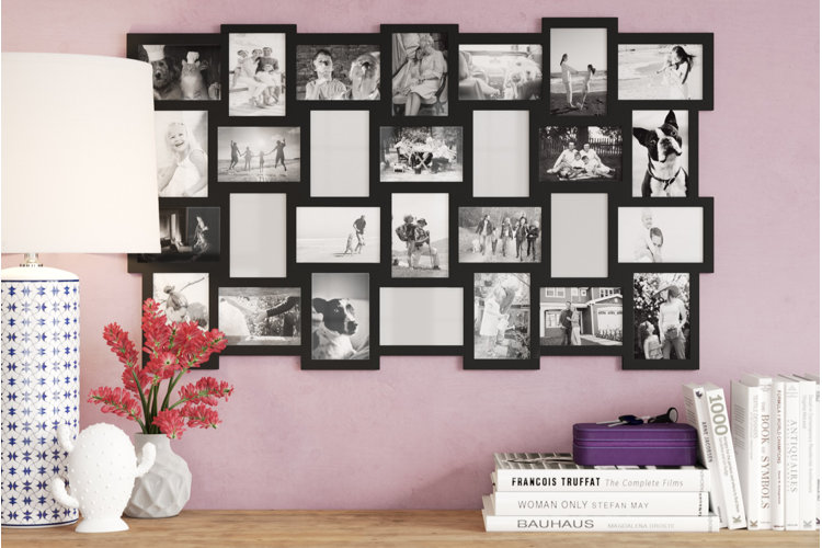 black collage picture frame displaying collection of black-and-white family and pet photos
