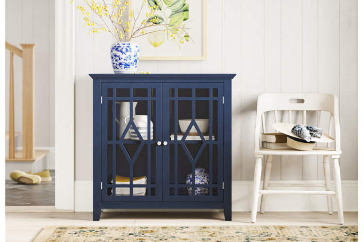 farmhouse-style dining room with a bright royal blue accent cabinet