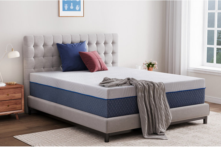 firm memory foam mattress on gray upholstered bed frame