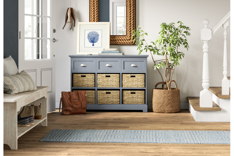 coastal-style entryway with a blue hallway runner and a distressed wooden entryway bench