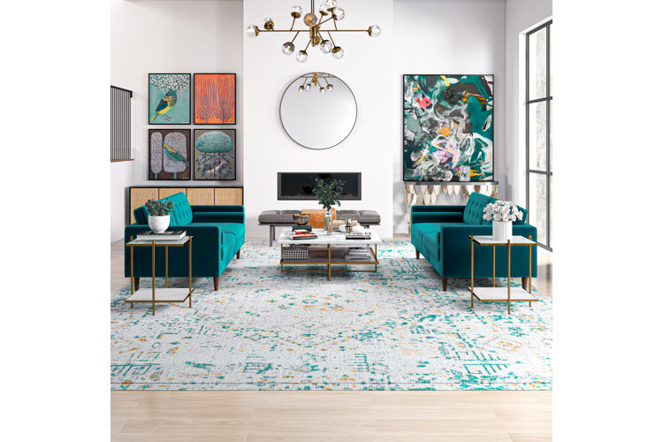 Modern living room with teal sofas, a teal patterned area rug, and teal abstract art.