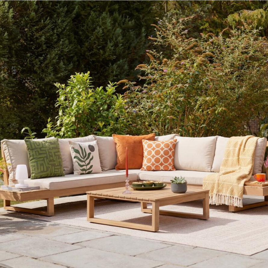 Outdoor seating area with sofa and chairs.