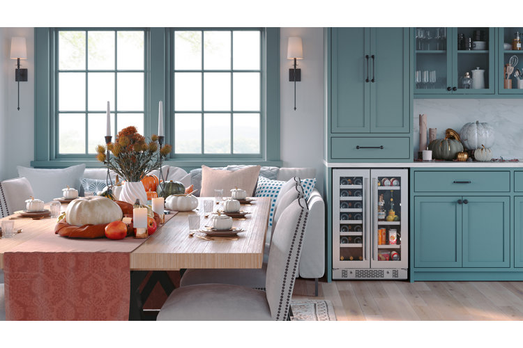transitional dining area with blue cabinetry, a fall tablescape, and a built-in beverage fridge