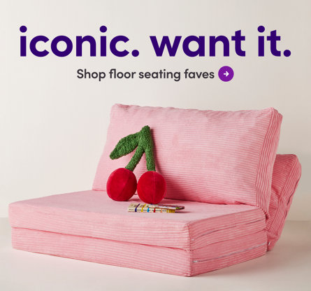iconic. want it. Shop floor seating faves. Pink corduroy convertible floor sofa with cherry-shaped pillow and books