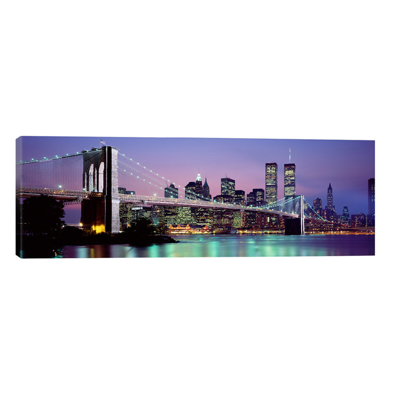 An Illuminated Brooklyn Bridge With Lower Manhattan's Financial District Skyline In The Background, New York City, New York - No Frame Panoramic Print on Canvas