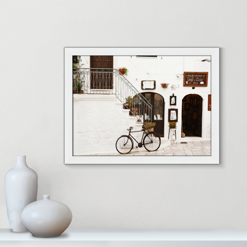 La Bottega D'Arte by Bogdan Dada, 18" H x 24" W x 0.75" D, White Framed