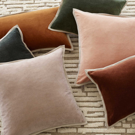 Assorted decorative pillows on an area rug.