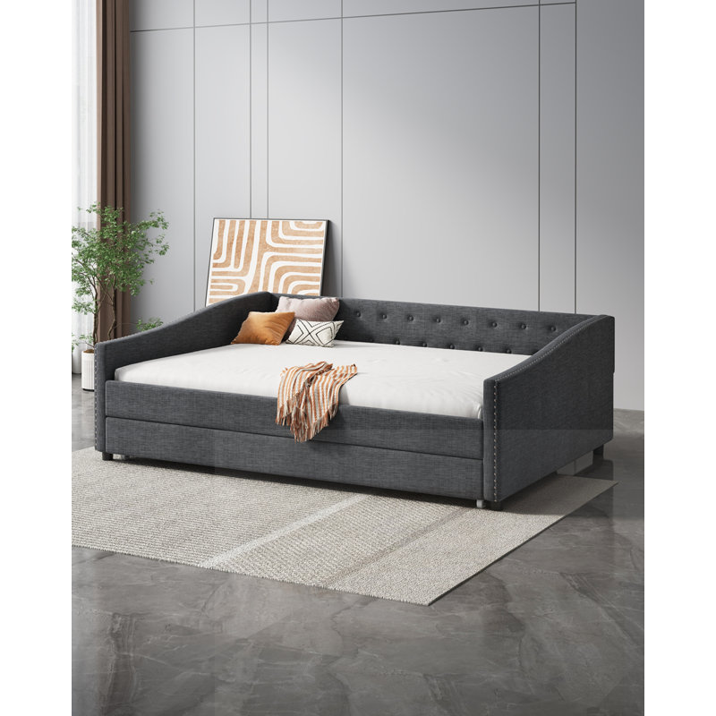 Élégant lit de jour avec lit gigogne et rangement, combinant des sièges confortables et un espace de couchage supplémentaire pour les maisons modernes.