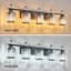 Luminaire de meuble-lavabo de salle de bain moderne en cristal 5 lumières au fini noir sable et abat-jour en cristal transparent K9 pour installation sur miroir