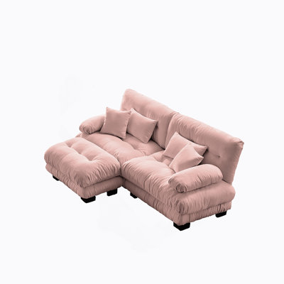Luxueux canapé en chenille pour le salon avec plusieurs coussins et repose-pieds convertible, pour plus de confort et de style.