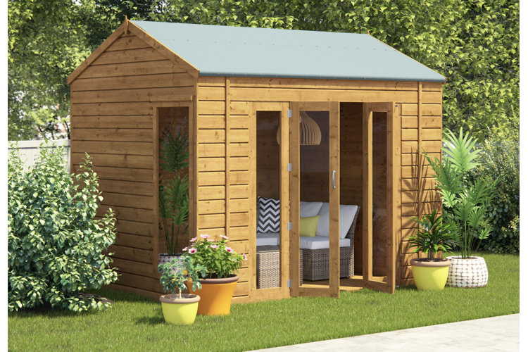 Wooden she shed with windows, glass doors, and a sofa.