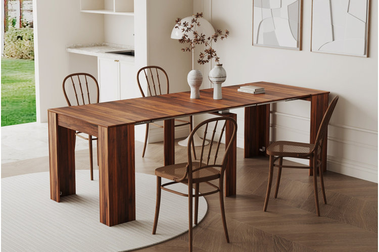 extendable wood dining table with slim dining chairs in bright dining room