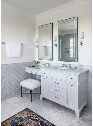 traditional bathroom with marble floor tiles and a half wall of gray brick tiles