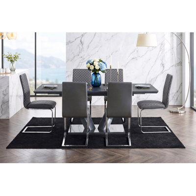 Table de salle à manger moderne et luxueuse à finition frittée avec plateau en forme de V et piédestal en chrome