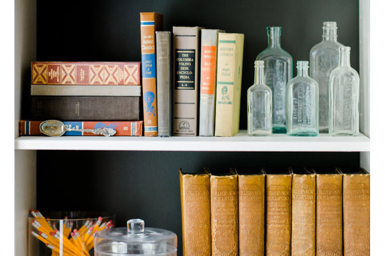 Vintage book and bottle shelf vignette