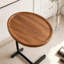 Table d'appoint en forme de C avec plateau en MDF et structure métallique robuste, idéale pour les petits espaces.
