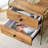 Double-drawer bedside table. The board surface is MDF with wood grain sticker, and both sides are transparent tempered glass. The design is simple and elegant, with excellent storage functions.