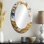 Silhouette de femme africaine dorée Basswoo I - miroir mural ovale traditionnel doré