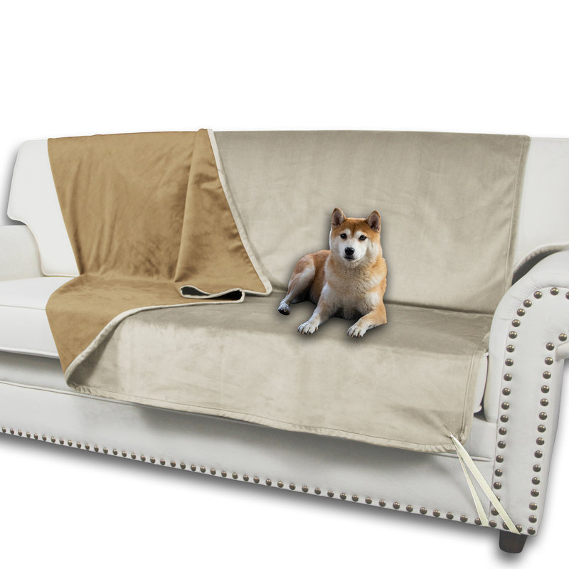 Reversible beige and tan pet furniture protector draped over a white sofa with a Shiba Inu resting on it