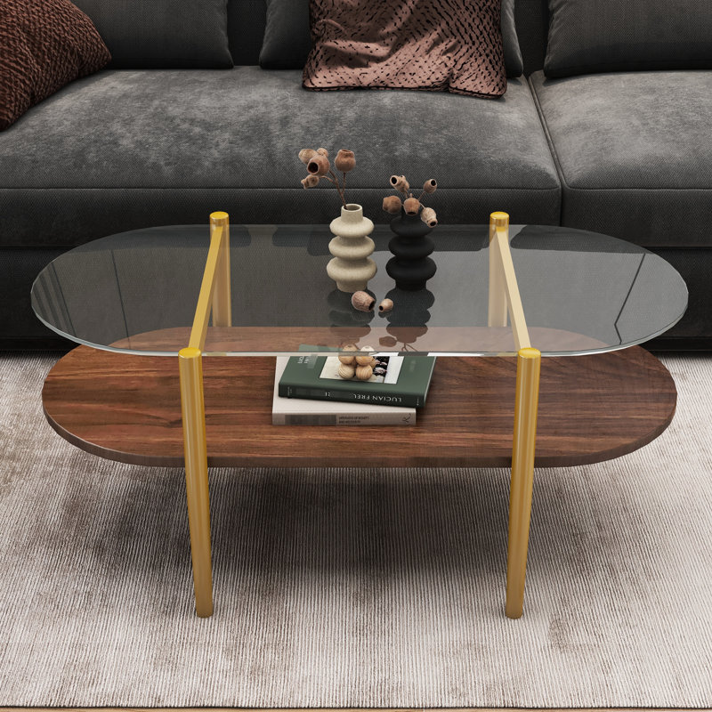Table basse ovale en verre pour salon, 104 cm de longueur, double tablette, transparente et brune, pieds fuselés, structure de pièce.