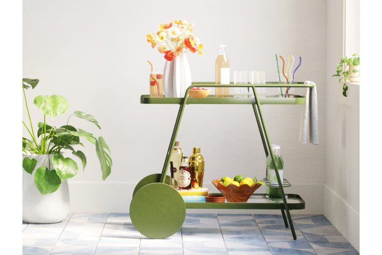 Small space home bar cart with an assortment of alcohol bottles, glassware, and mixology tools