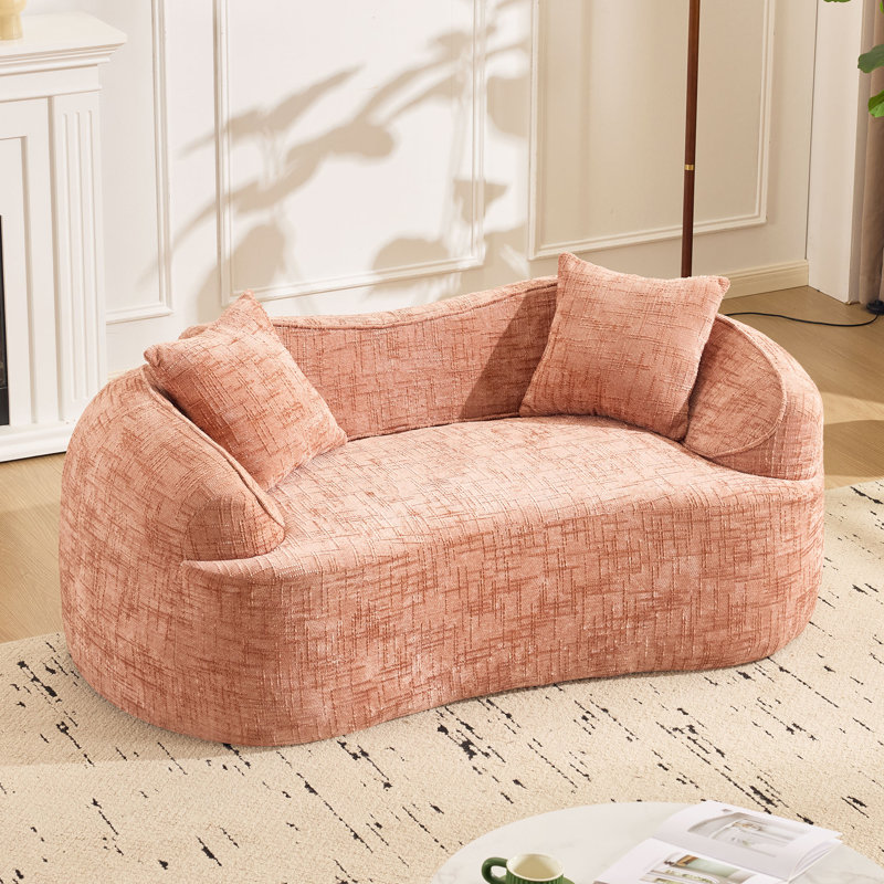 Pink Curved Two - Person Compress Sofa. It Has Armrests On Both Sides, Pink